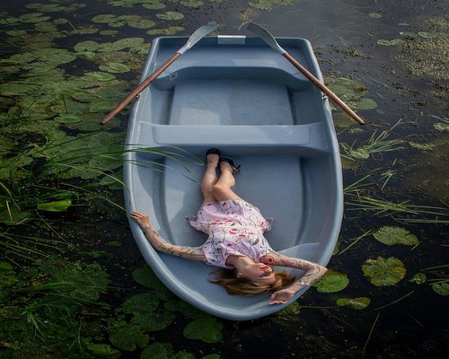 A person enjoying a coffee while working on a laptop near a bright window in Santiago