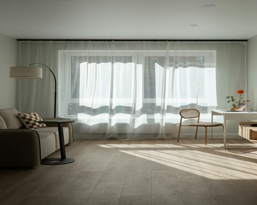Soft natural light filtering through sheer curtains in a living room